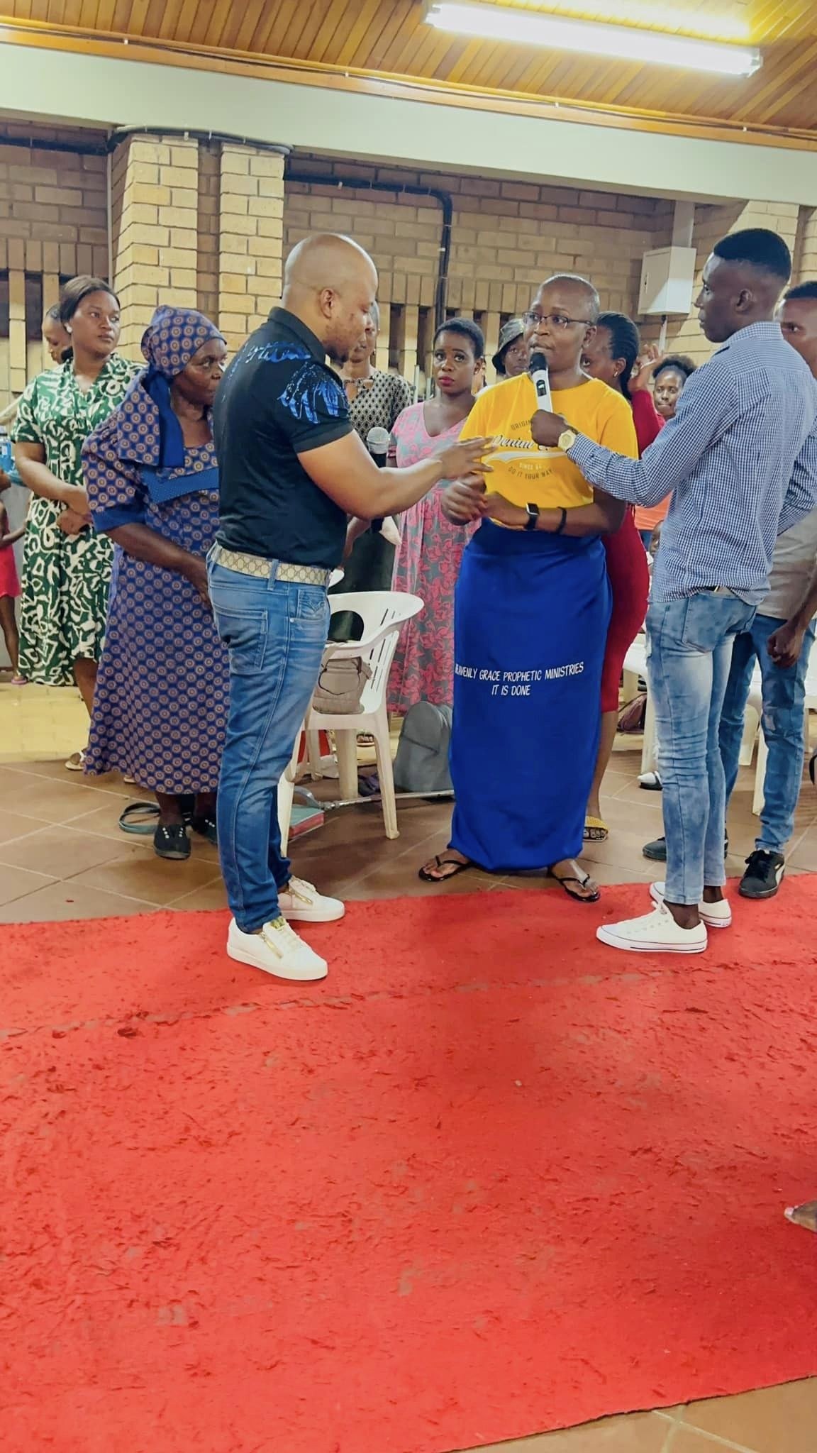 Prophet Matimba Nyandane listening as a woman speaks during a church gathering