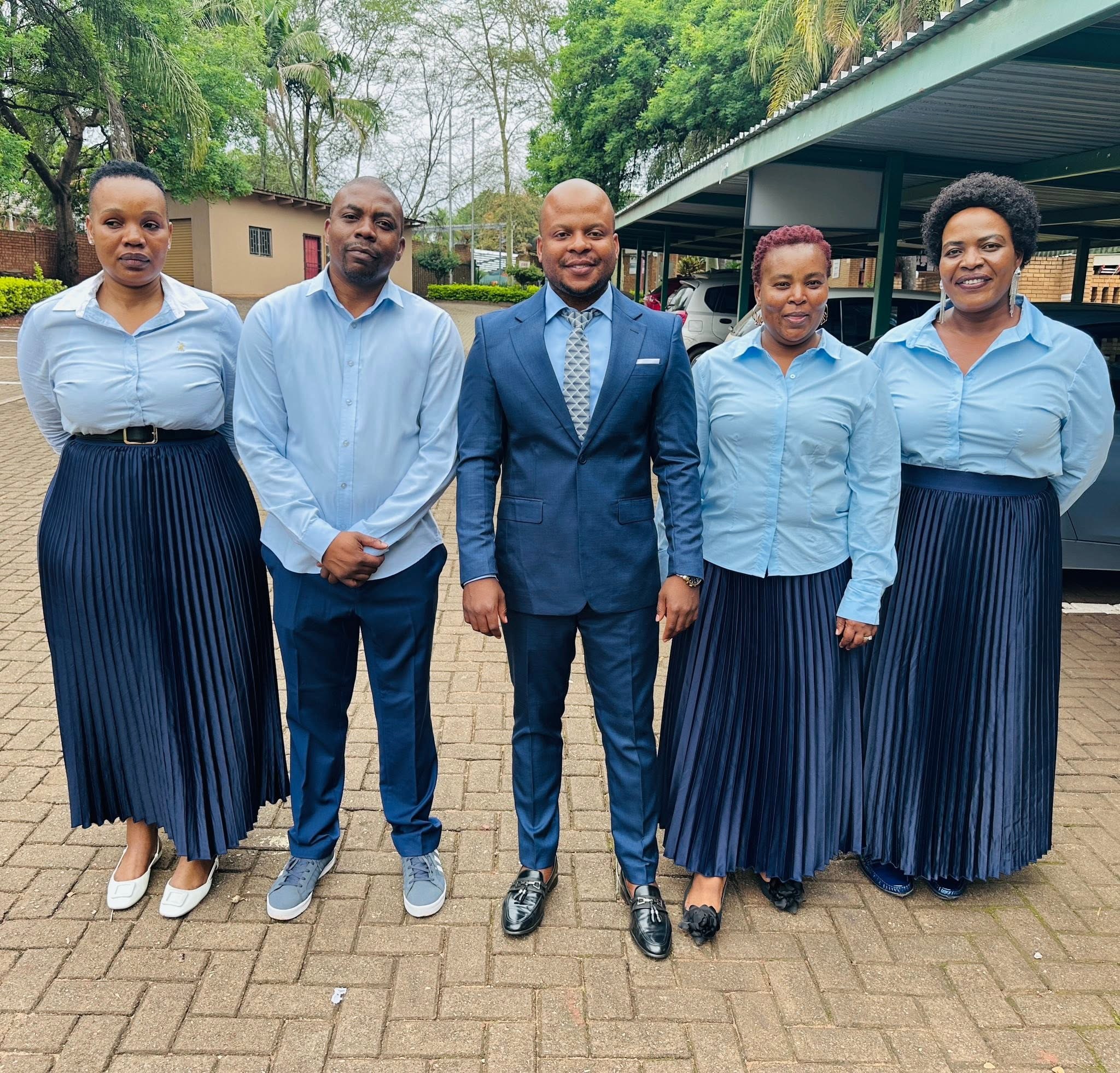 Prophet Matimba Nyandane standing outdoors with four members of the Heavenly Grace ministry team